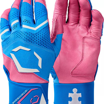 A pair of kids' athletic gloves in pink and blue, showing both the back of one glove and the palm of the other. The gloves feature a blue mesh back, pink leather palms, white geometric logo accents, and a blue wrist strap with a white puzzle-piece logo.