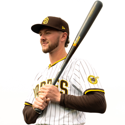 Padre Jackson Merrill holding a bat with a white background